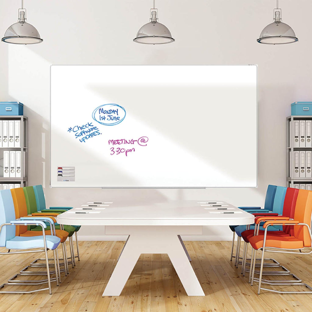 Modern conference room with a whiteboard, colourful chairs, and a large table.