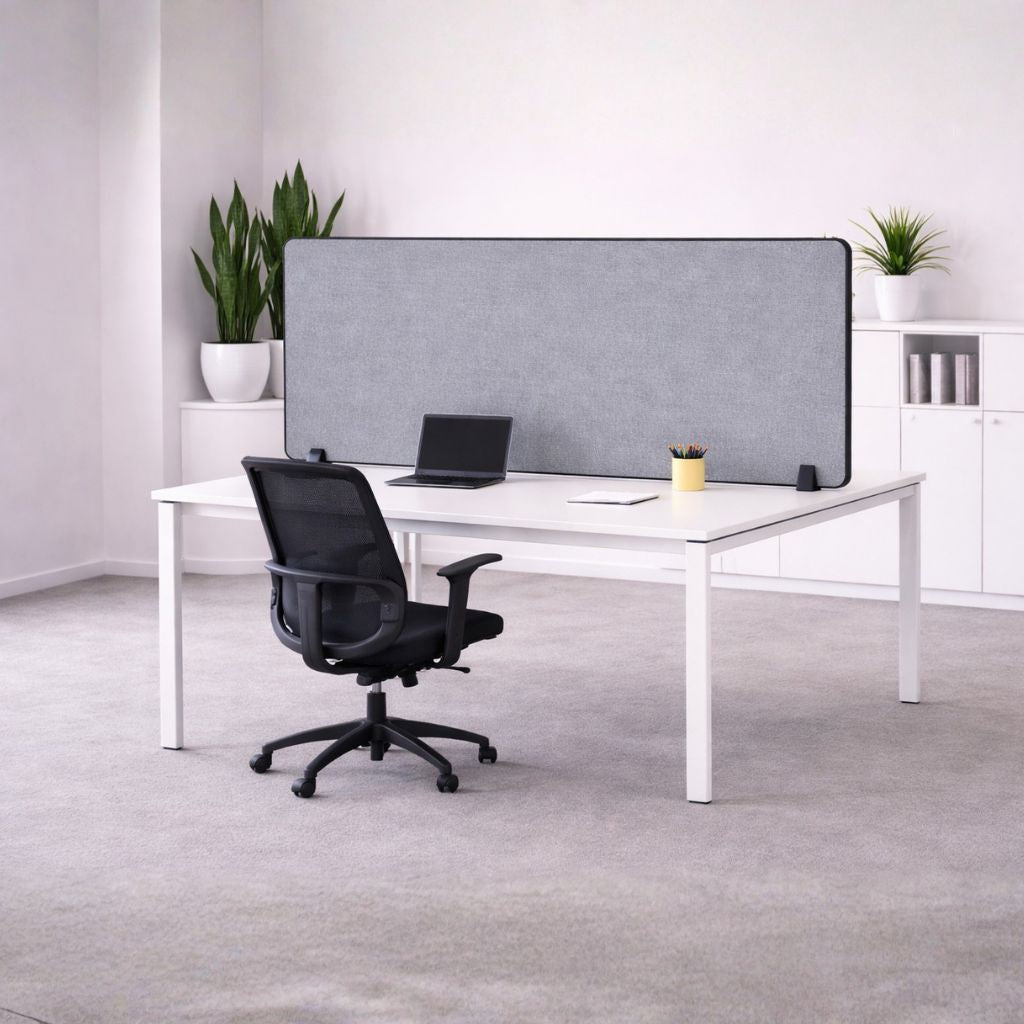 Modern office desk setup with a chair, laptop, and partition screen in a bright room.
