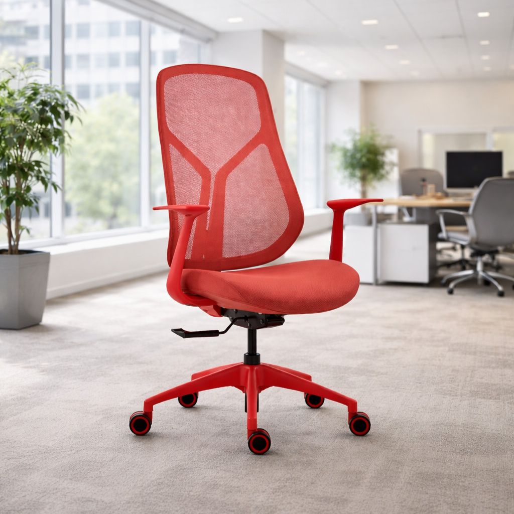 Red office chair in a modern office setting with large windows.