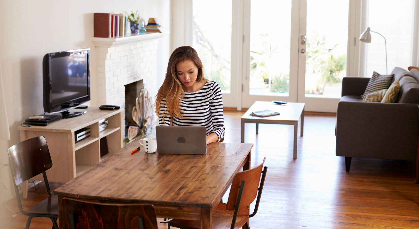 woman working from dinner table
