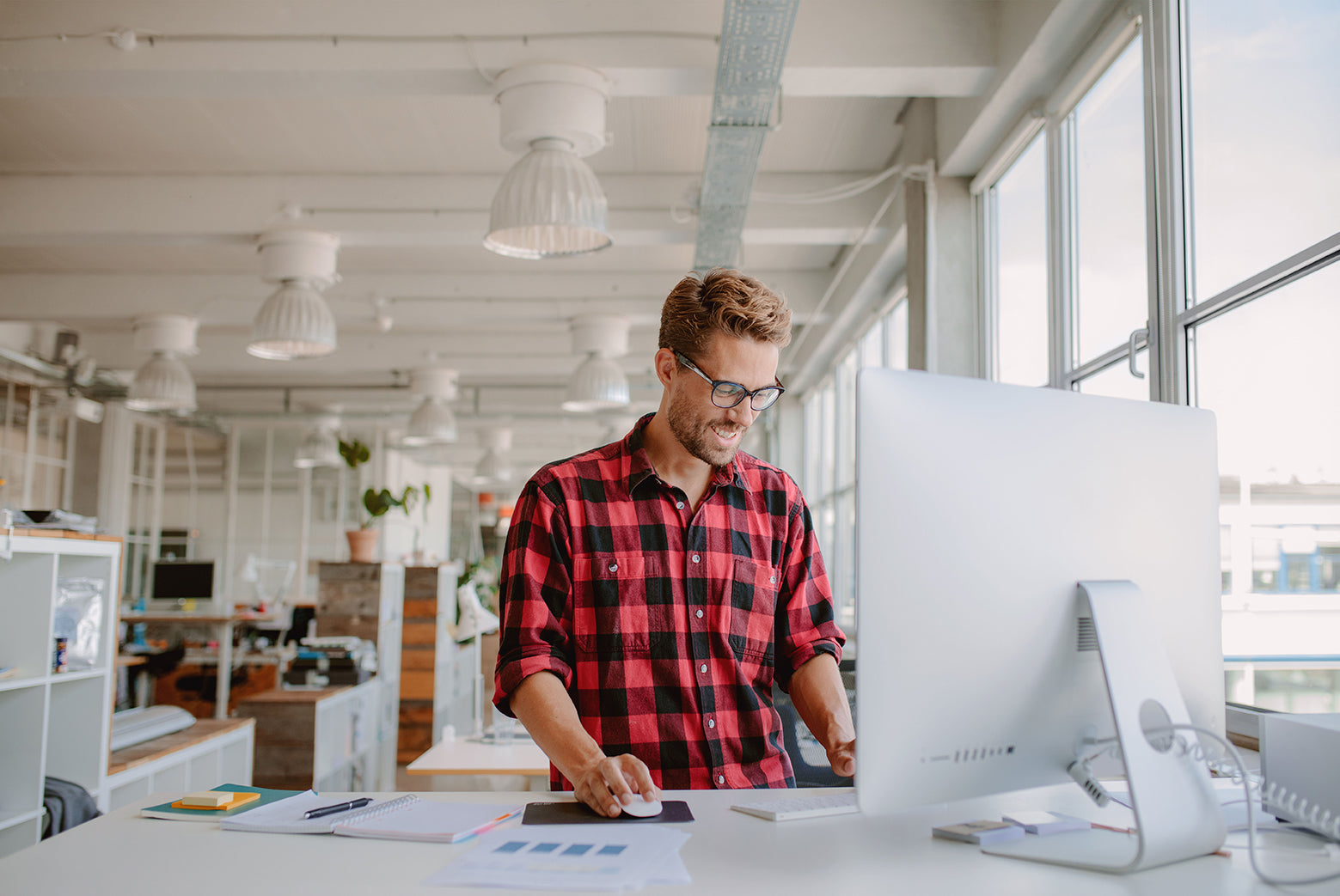 smiling man at standing desk