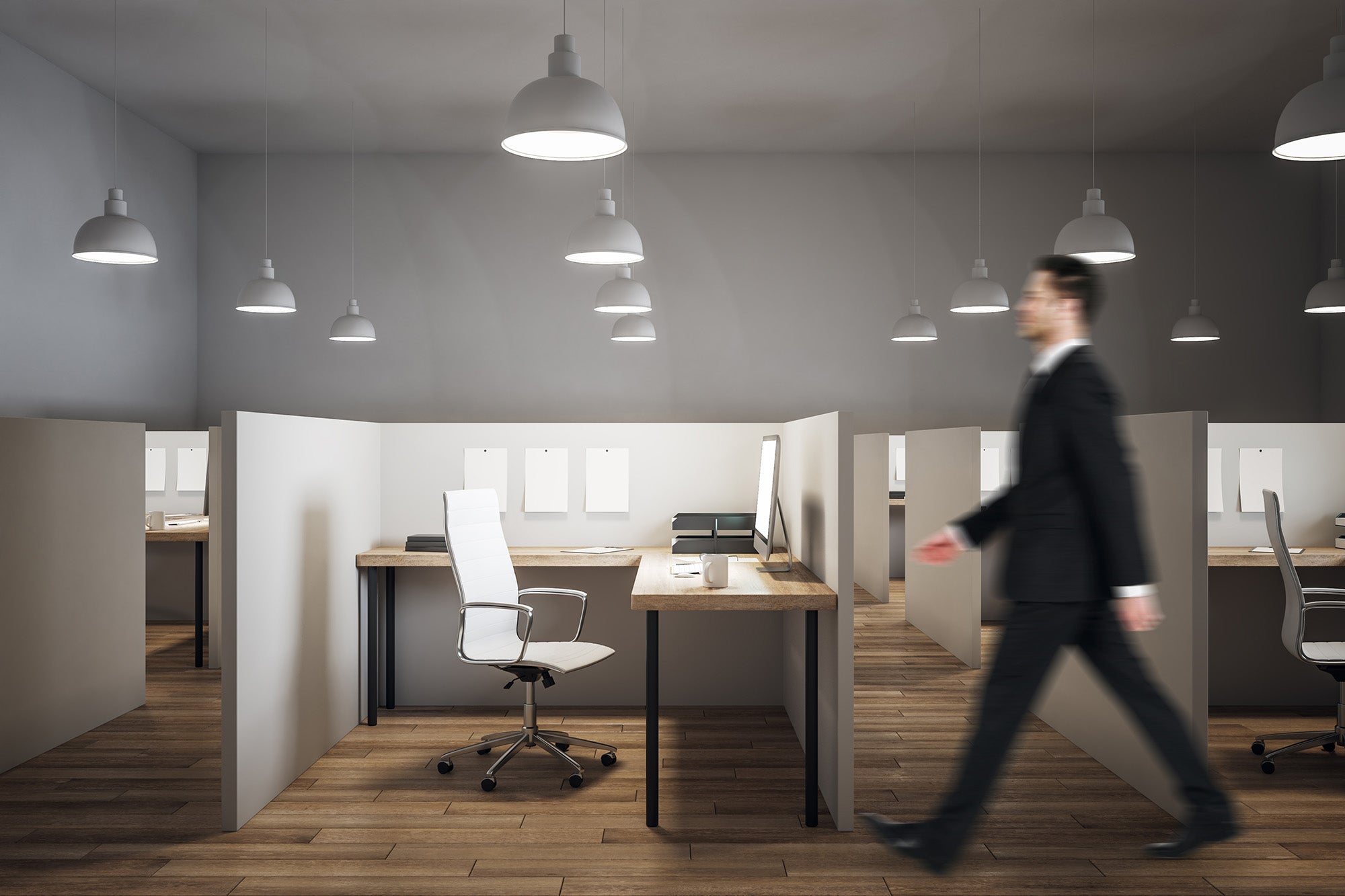 man walking past corner desk