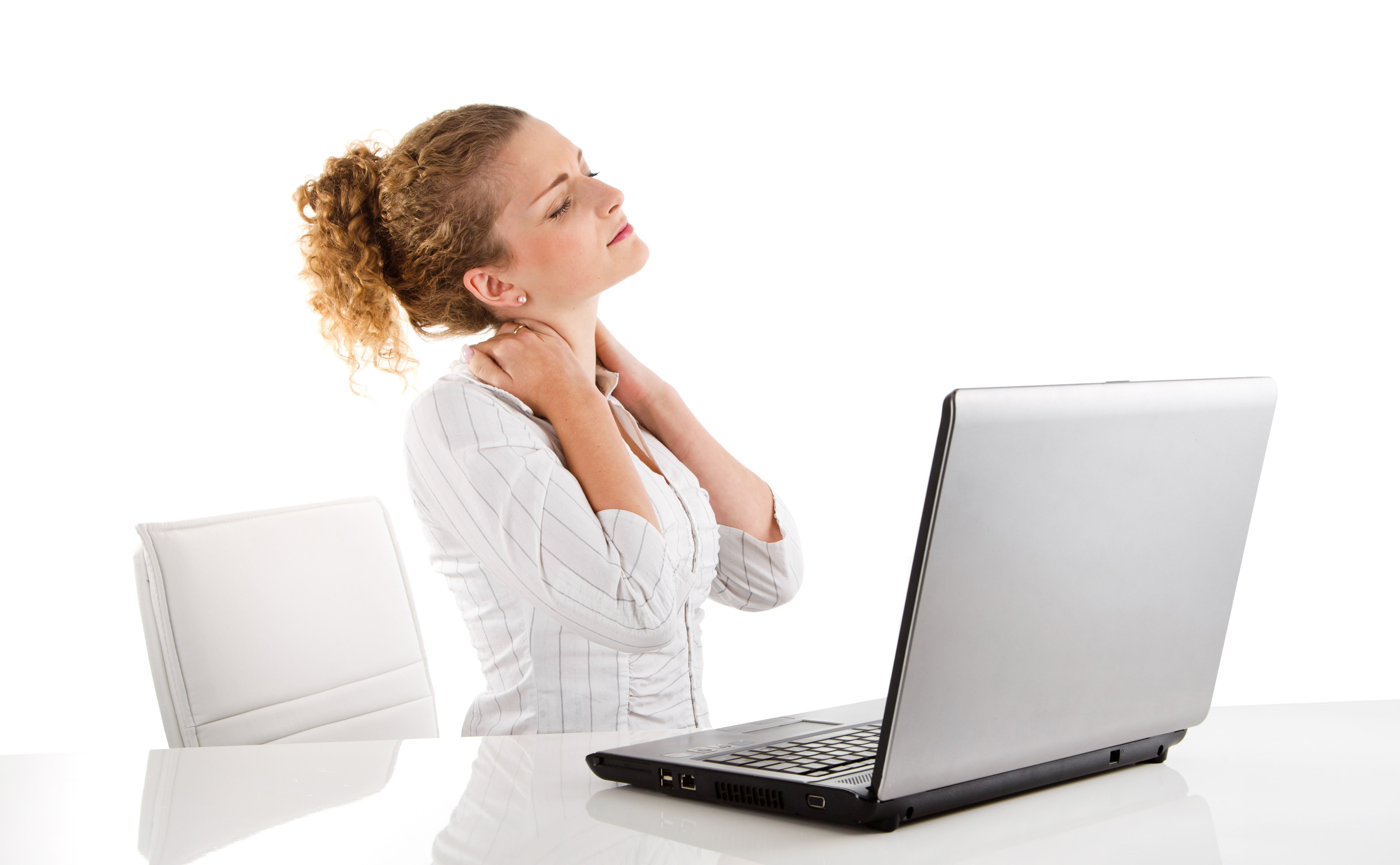 woman straining neck at desk