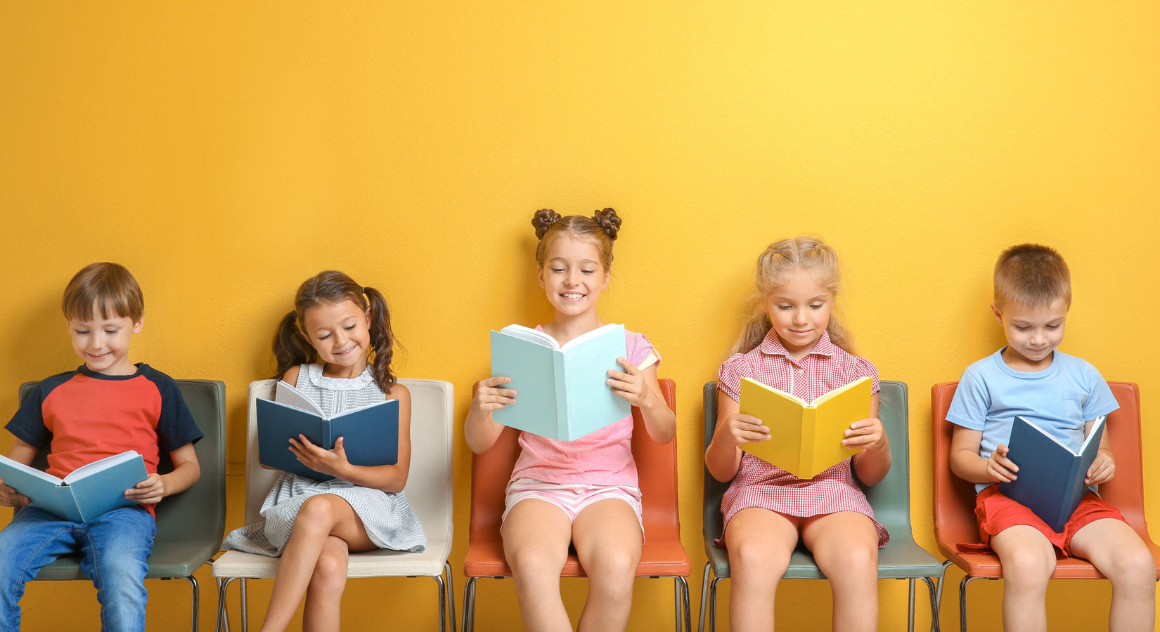 kids sitting on chairs reading