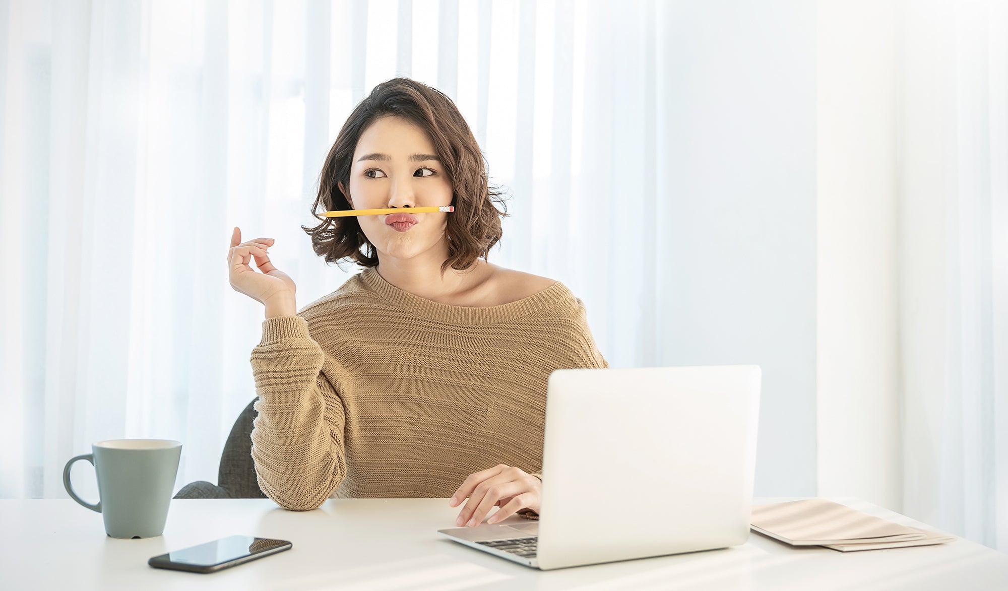 young woman at home office thinking