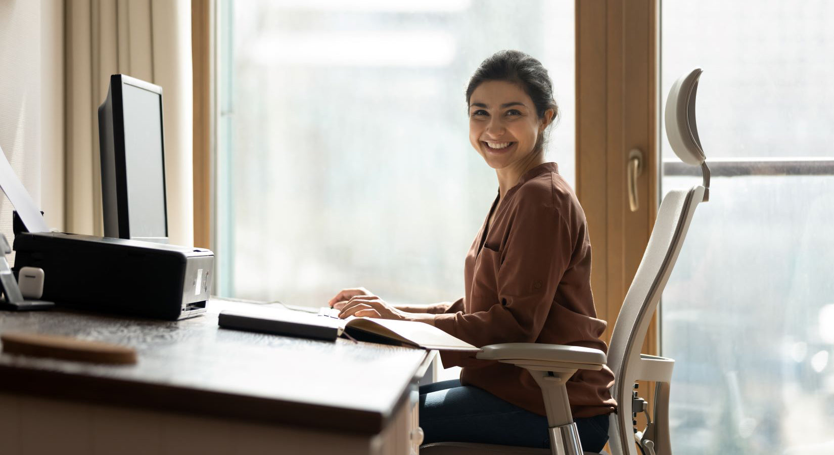 young woman sitting at her desk