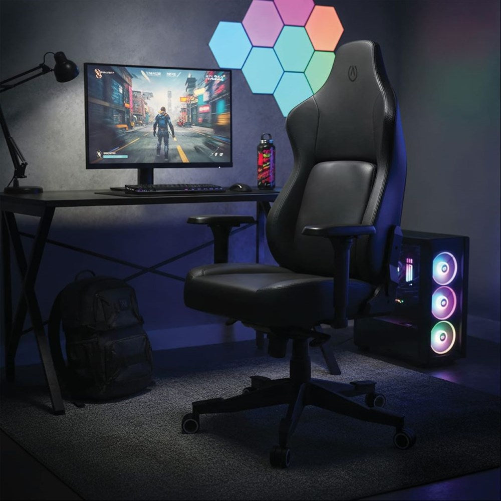 Gaming setup with chair, monitor, and RGB lighting in a dark room