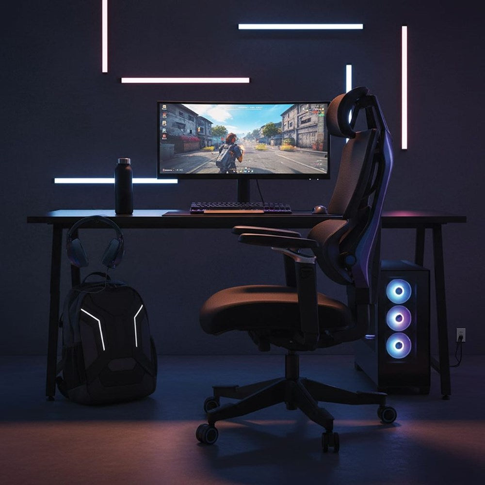 Gaming setup with chair, desk, and computer monitor in a dark room